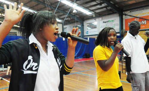 Sisters Robertine and Mary and Panyar rapped to their peers as part of Orara High School’s Refugee Week celebrations yesterday. Sisters Robertine and Mary and Panyar rapped to their peers as part of Orara High School’s Refugee Week celebrations yesterday.